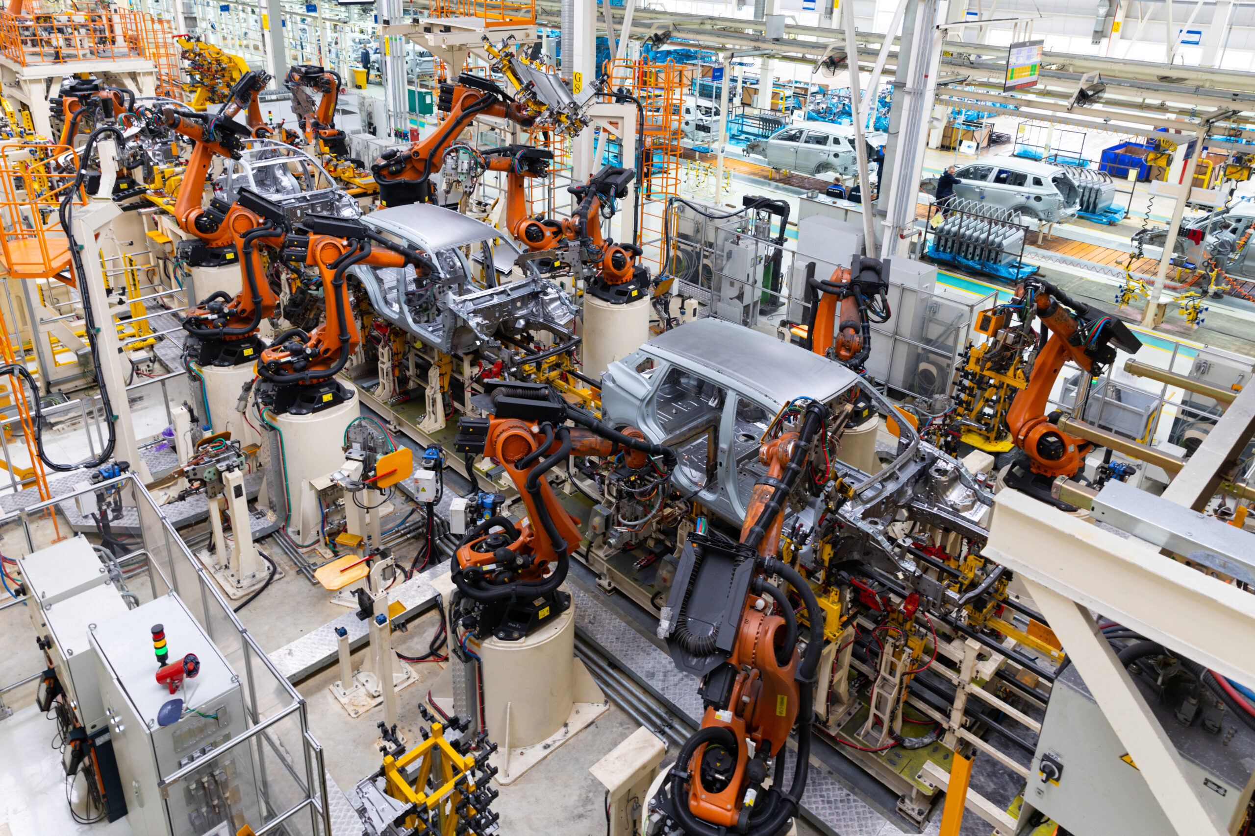 Car bodies are on assembly line. Factory for production of cars. Modern automotive industry. Electric car factory, conveyor.